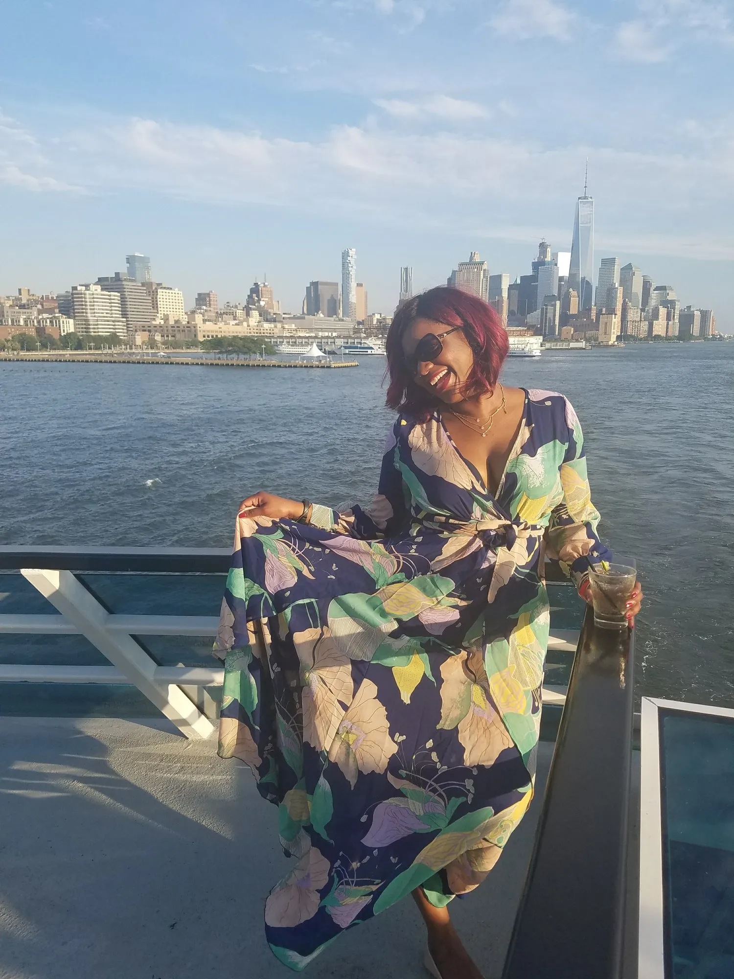 Natalia Brown on a boat deck with the Lower Manhattan skyline behind her